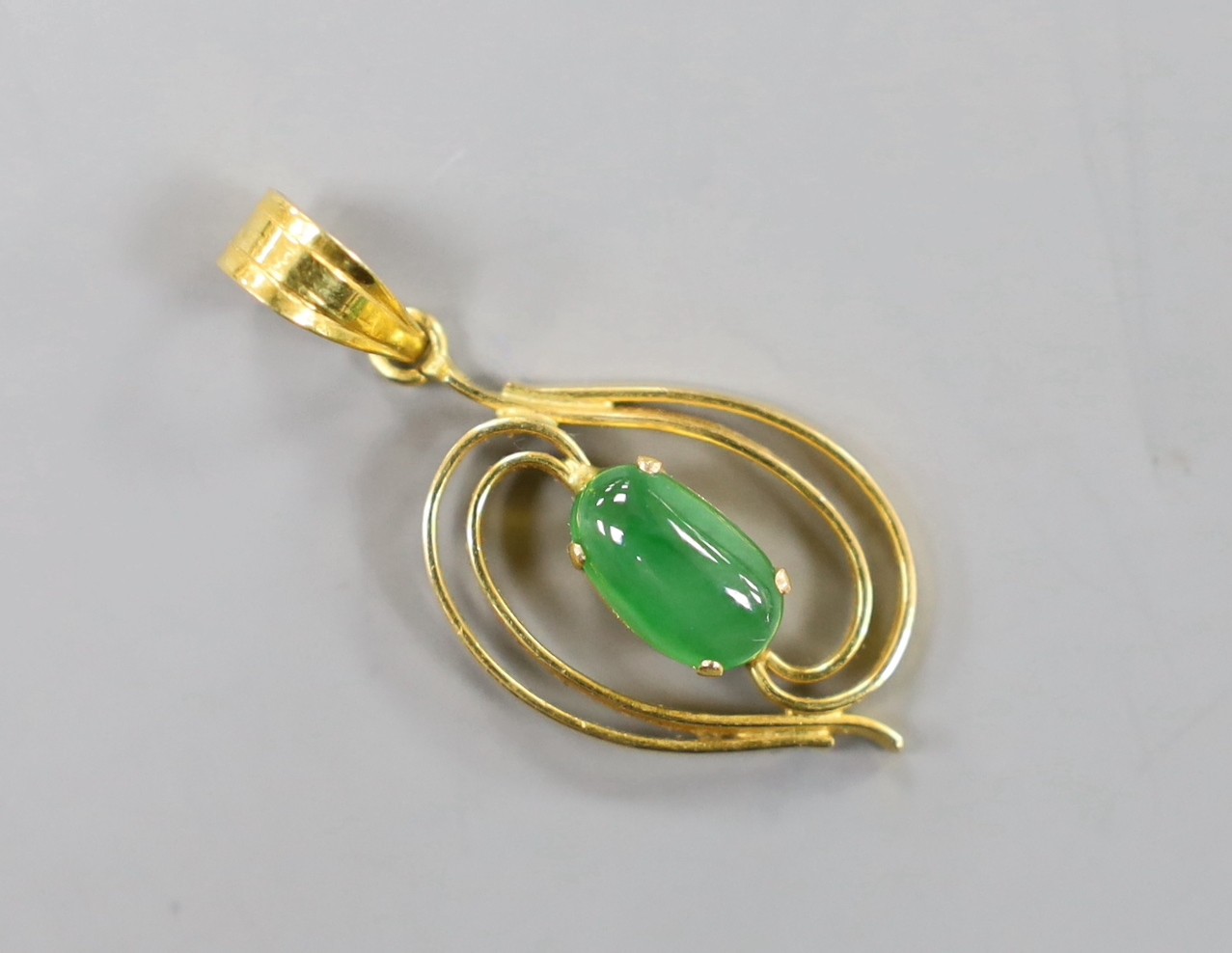 A yellow metal and single stone cabochon jade mounted pendant, overall 31mm, gross weight 2.2 grams.